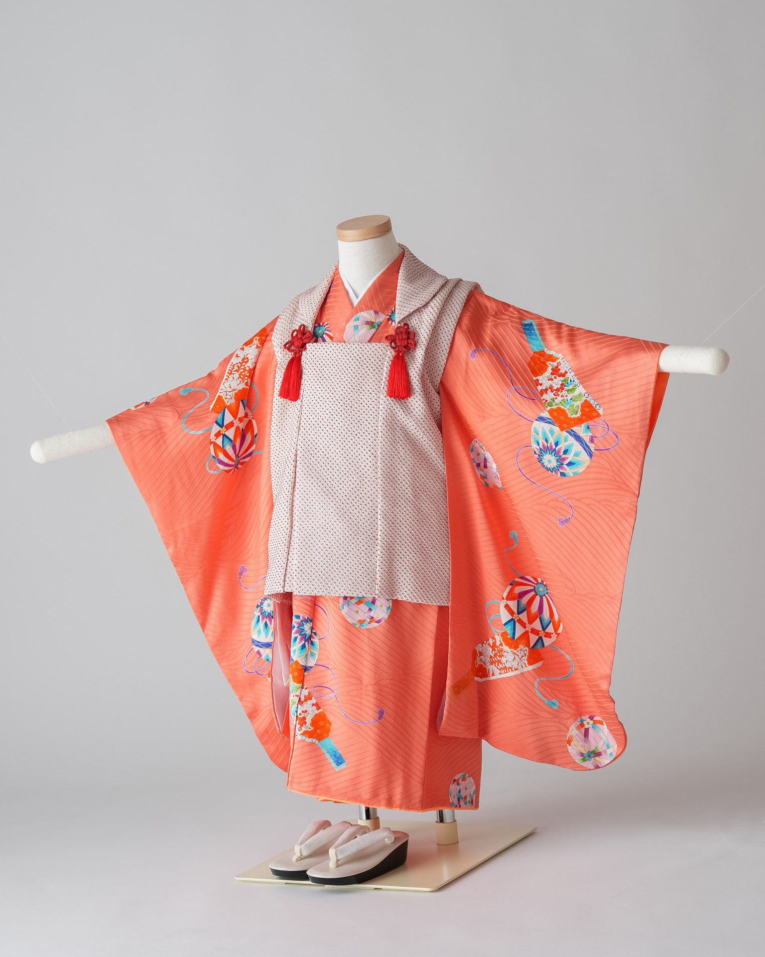 オレンジ色の着物に白い被布を合わせた三歳女の子用の七五三衣装セット
